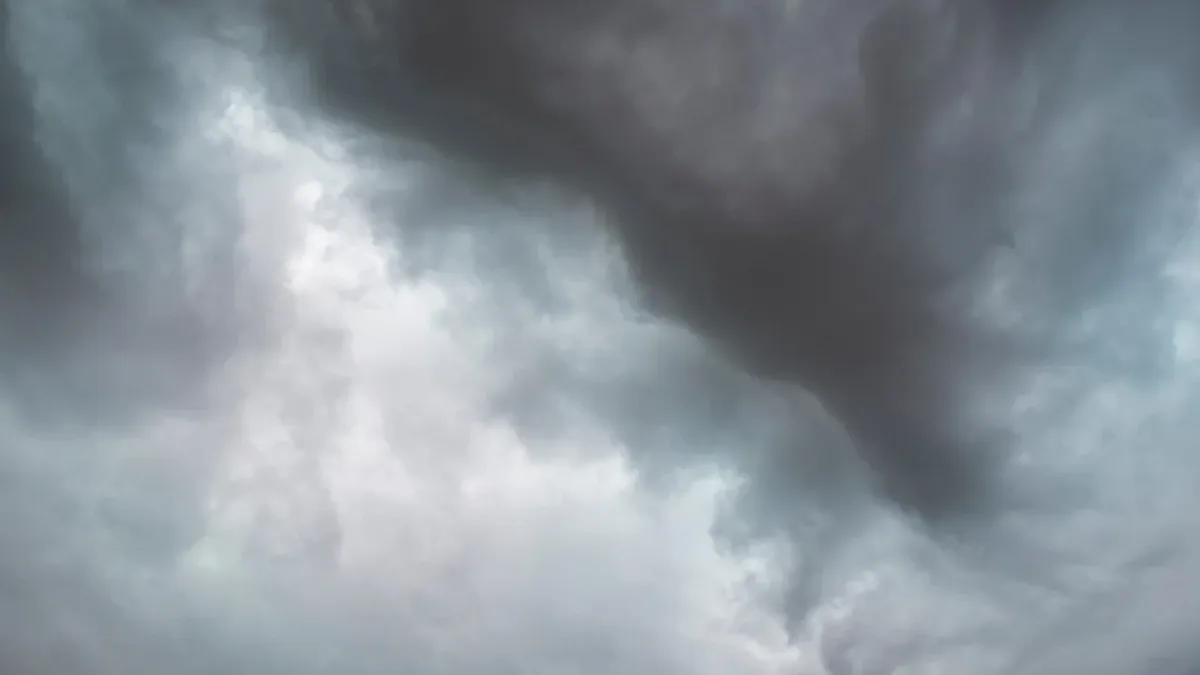 A dark and ominous sky with clouds that appear to be moving quickly, suggesting a storm or severe weather event.